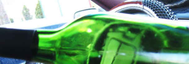 Car steering wheel through a bottle of wine